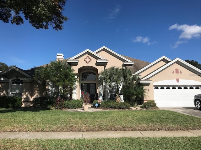 view of front of home with a front lawn and a garage