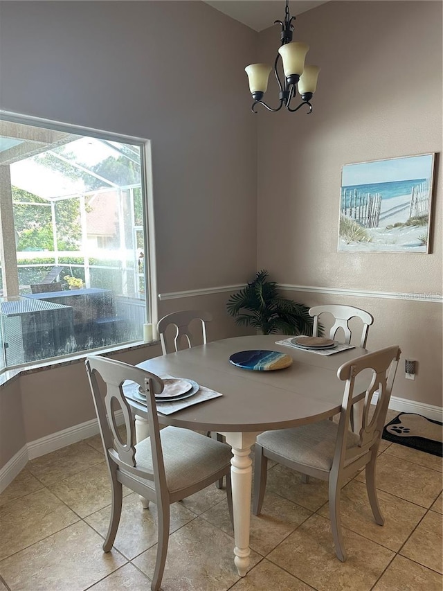 tiled dining room featuring a chandelier