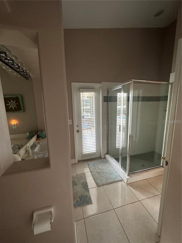 bathroom featuring tile patterned floors and an enclosed shower