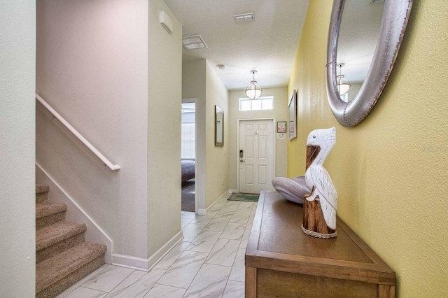 doorway to outside with marble finish floor, baseboards, stairway, and visible vents