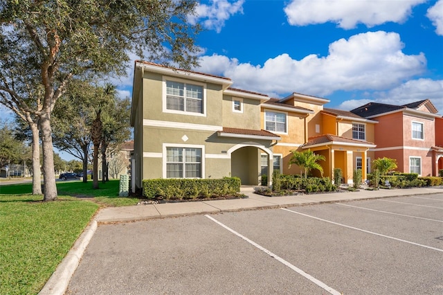 view of property featuring a front lawn