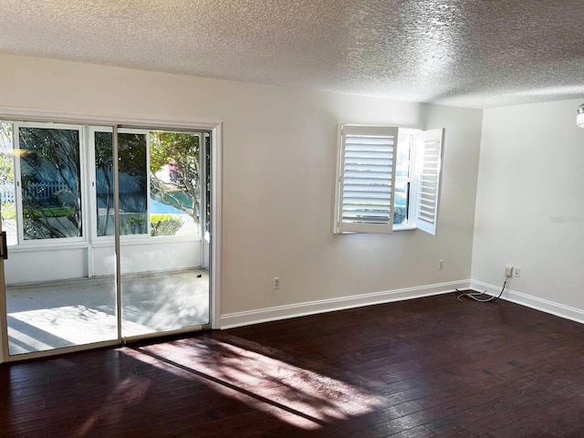9319 SE 173rd Hyacinth St, The Villages, FL 32162 - unfurnished room featuring dark wood-style floors, baseboards, and a textured ceiling