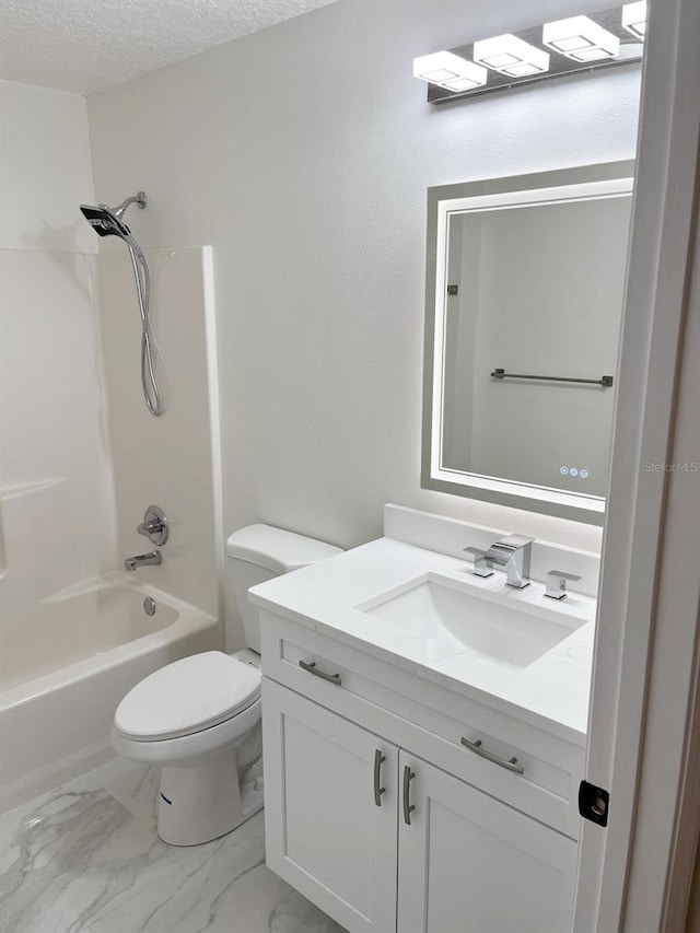 9319 SE 173rd Hyacinth St, The Villages, FL 32162 - bathroom featuring toilet, marble finish floor, a textured ceiling, vanity, and shower / bathing tub combination