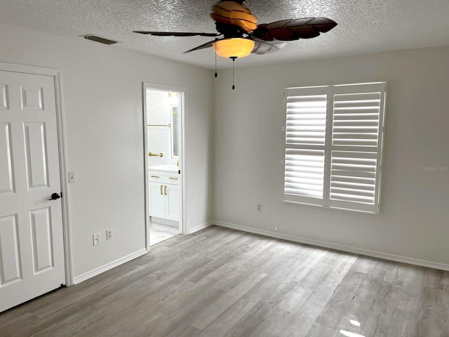9319 SE 173rd Hyacinth St, The Villages, FL 32162 - unfurnished bedroom featuring baseboards, visible vents, a textured ceiling, and light wood finished floors