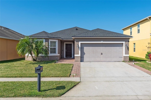 view of front of property featuring a front yard and a garage