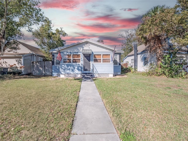 bungalow featuring a lawn