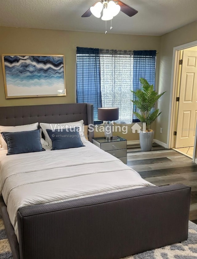 bedroom featuring ceiling fan, wood finished floors, and baseboards