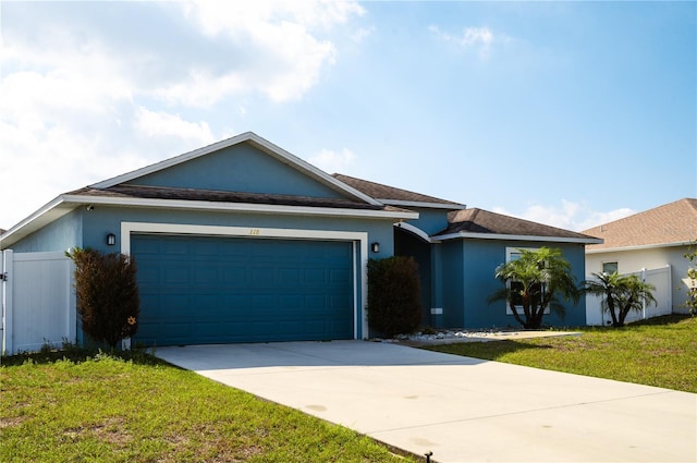 single story home with a garage and a front yard