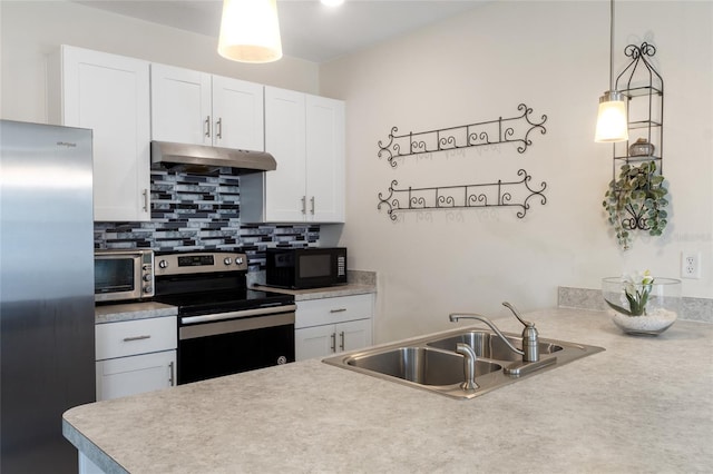 kitchen featuring white cabinets, under cabinet range hood, appliances with stainless steel finishes, and light countertops