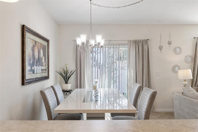 dining area with light carpet and a notable chandelier