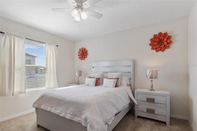 carpeted bedroom featuring a ceiling fan and baseboards