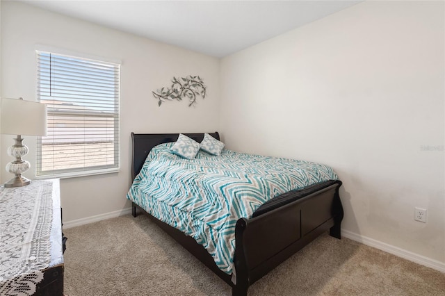 carpeted bedroom featuring baseboards
