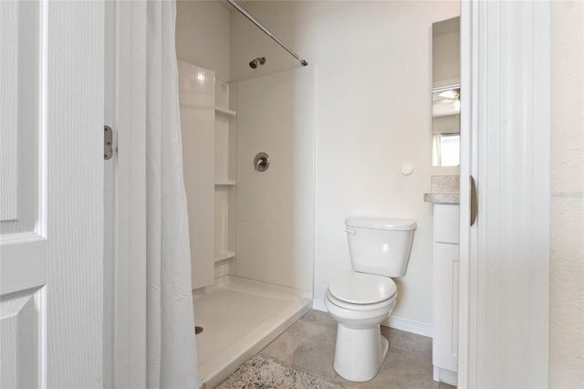 bathroom with tile patterned flooring, baseboards, a shower stall, and toilet