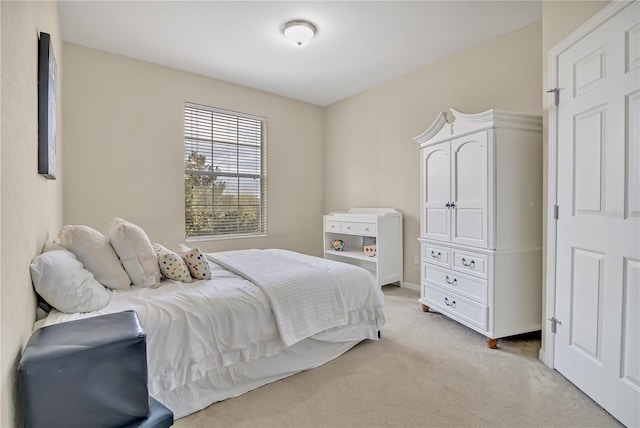 bedroom featuring light carpet