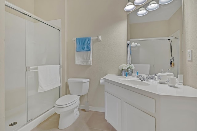 bathroom with toilet, a stall shower, vanity, and tile patterned floors