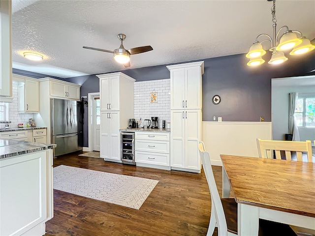 3004 Lake Margaret Dr, Orlando, FL 32806 - kitchen featuring freestanding refrigerator, beverage cooler, decorative backsplash, a ceiling fan, and a textured ceiling