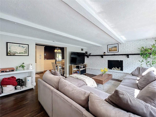 3004 Lake Margaret Dr, Orlando, FL 32806 - living room featuring wood finished floors, a textured ceiling, beamed ceiling, brick wall, and a fireplace