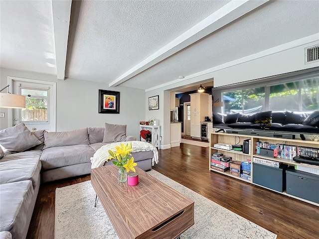 3004 Lake Margaret Dr, Orlando, FL 32806 - living room featuring dark wood-type flooring, beam ceiling, a textured ceiling, and beverage cooler