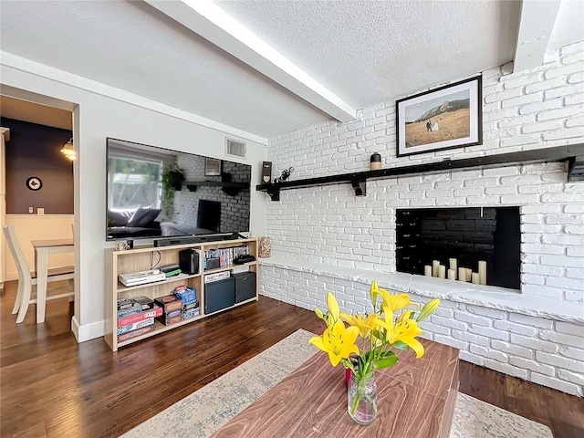 3004 Lake Margaret Dr, Orlando, FL 32806 - living area featuring beamed ceiling, dark wood-style floors, and a textured ceiling