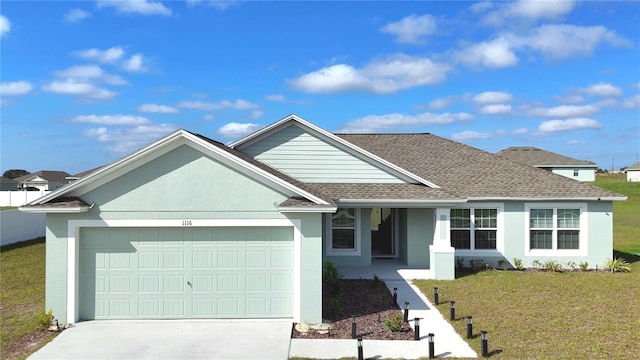 ranch-style home with a front yard and a garage