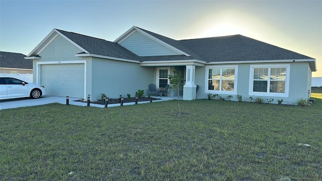 view of front of property featuring a garage and a lawn