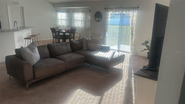 living room with plenty of natural light and carpet flooring