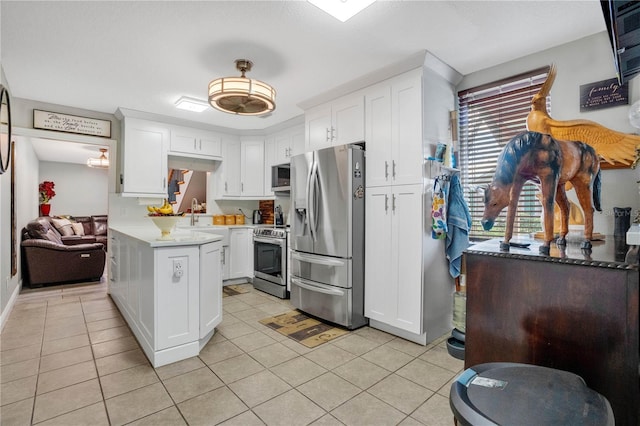 kitchen featuring white cabinets, light tile patterned floors, and stainless steel appliances