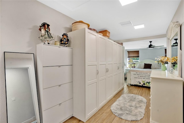 interior space with a closet, visible vents, and light wood-style flooring