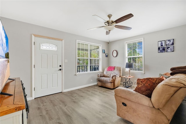 entrance foyer with ceiling fan, baseboards, and light wood-style floors