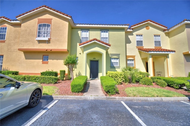 500 Monroe Cir, Davenport, FL 33896 - view of front of house with uncovered parking, a tile roof, and stucco siding