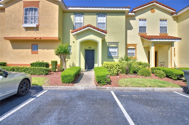 500 Monroe Cir, Davenport, FL 33896 - view of front of home featuring a tiled roof, uncovered parking, and stucco siding