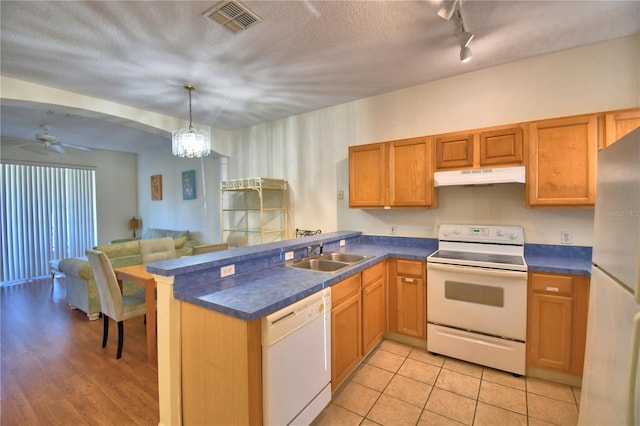 500 Monroe Cir, Davenport, FL 33896 - kitchen with a sink, dark countertops, under cabinet range hood, and white appliances