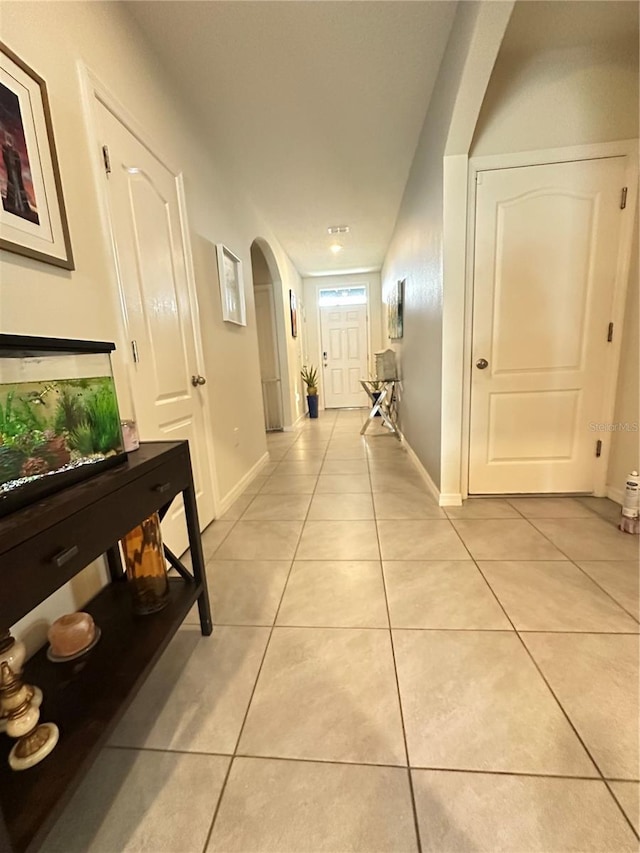 corridor with light tile patterned flooring