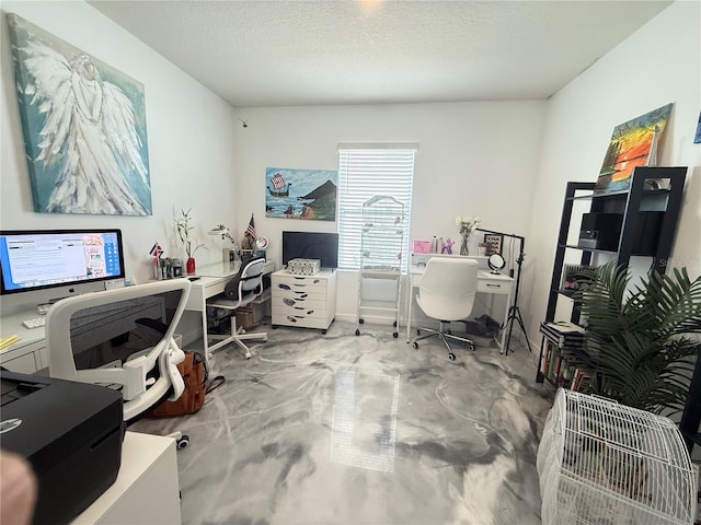 office area with a textured ceiling and concrete flooring