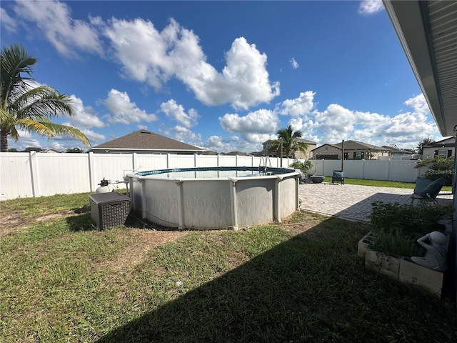 view of yard with a fenced in pool