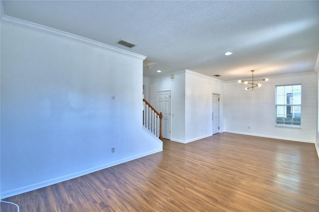 unfurnished room featuring dark wood-style floors, visible vents, stairway, a chandelier, and baseboards