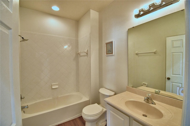 full bathroom with washtub / shower combination, vanity, toilet, and wood finished floors