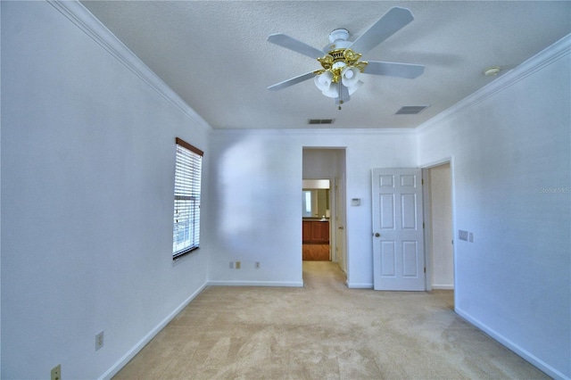 unfurnished bedroom featuring baseboards, light carpet, visible vents, and crown molding