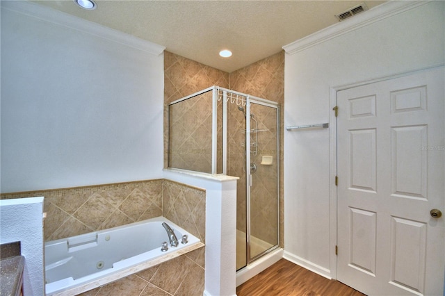 full bath featuring a stall shower, visible vents, a whirlpool tub, and wood finished floors