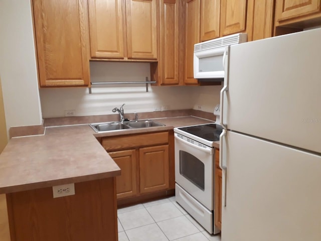 kitchen featuring white appliances, light countertops, a sink, and light tile patterned floors