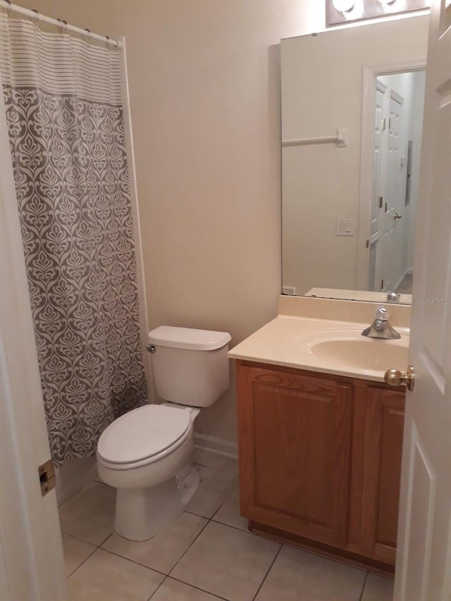 bathroom featuring vanity, toilet, and tile patterned floors