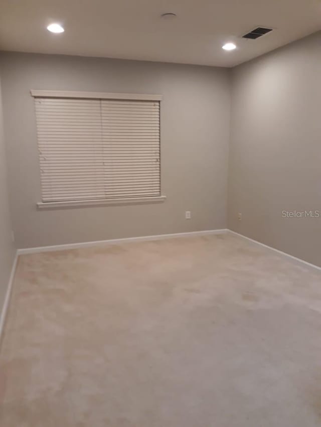 empty room featuring recessed lighting, baseboards, visible vents, and carpet flooring