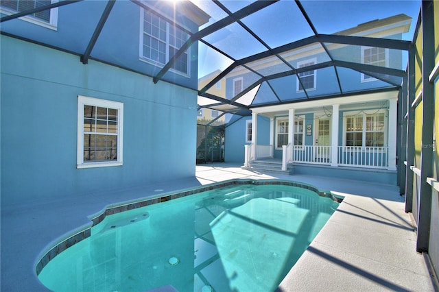 pool with a lanai, a patio area, and a ceiling fan