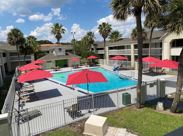 community pool featuring a patio area and fence