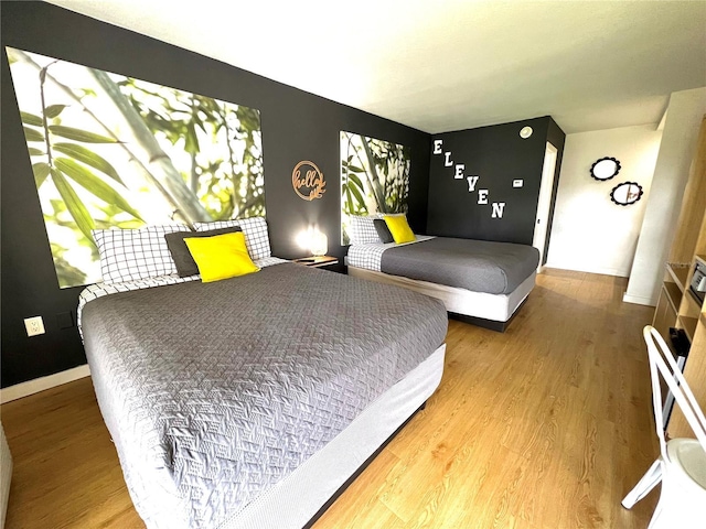 bedroom featuring baseboards and wood finished floors