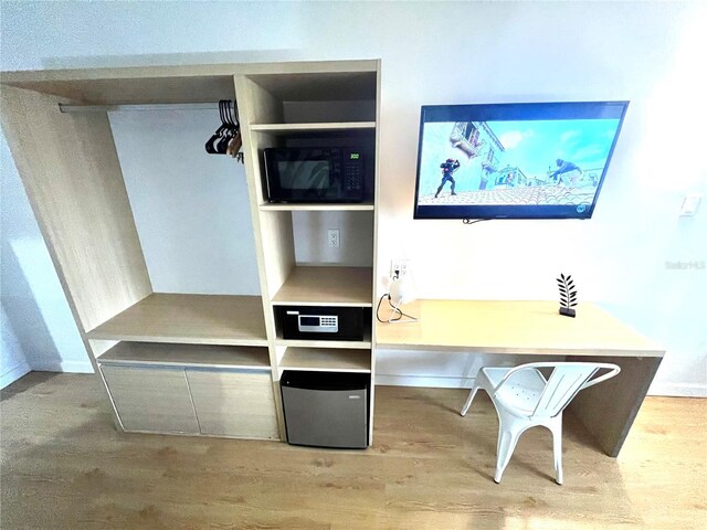 interior space featuring baseboards and wood finished floors