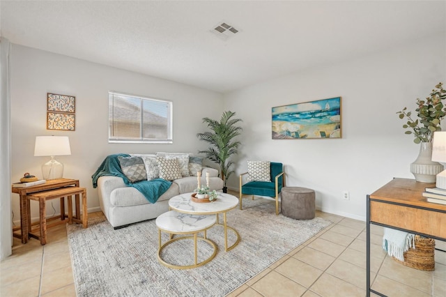 living area with light tile patterned floors, baseboards, and visible vents