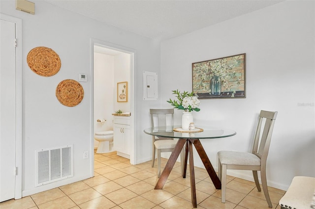 dining area featuring electric panel, visible vents, baseboards, and light tile patterned floors