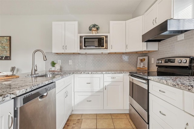 kitchen featuring a sink, white cabinets, light tile patterned floors, and stainless steel appliances