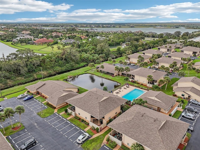 drone / aerial view with a residential view and a water view